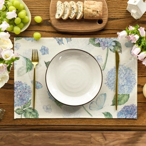 Tropical placemat with blue hydrangea and butterfly patterns on a rustic wooden table
