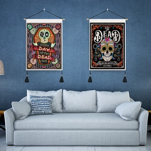 Detail of Day of the Dead tapestries with skull patterns and black tassels on wall