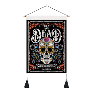 Detail of Day of the Dead tapestry featuring a colorful sugar skull and hanging tassels