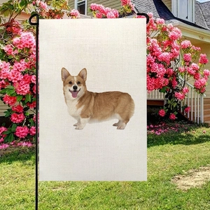 Double-sided linen garden flag with Corgi dog print on a black metal hanger in a yard
