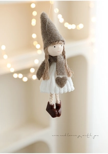 Detail eines Plüsch-Weihnachtsanhängers mit grauer Mütze, Stricktexturen und warmem Licht