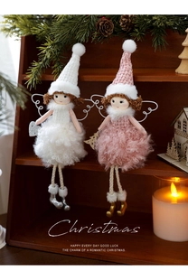 Detail of plush Christmas angel dolls with knitted hats on a festive wooden shelf