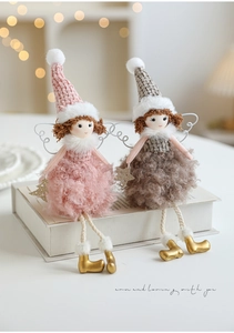 Detailed view of plush angel dolls with sequined stars and cozy knitted hats