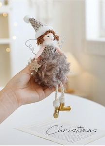 Close-up of plush Christmas angel doll with grey knit hat and golden boots