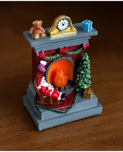 Detailed view of a miniature Christmas fireplace scene with Santa on a wooden table