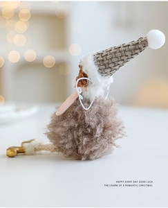 Detail of plush angel girl doll with grey knit hat and white wings for Christmas decor