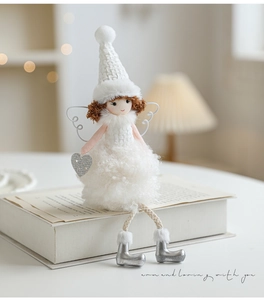 Detail of plush angel girl doll with white knit hat and silver wings for Christmas tree