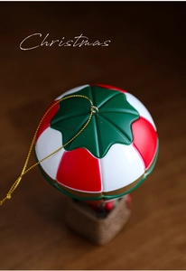 Detailed view of Christmas hot air balloon ornament with red white and green festive pattern