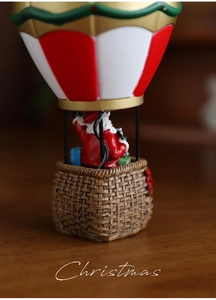 Close-up of a festive hot air balloon Christmas ornament with resin Santa and gift boxes