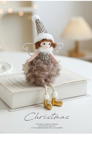 Detail of plush Christmas angel doll with gray faux fur and gold sequin star