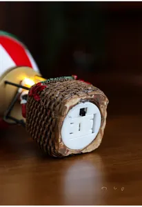 Detailed close-up of the bottom switch and battery compartment of a lighted resin ornament