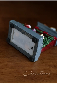 Detail view showing base with battery compartment and power switch for Christmas ornament
