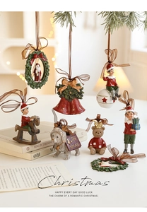 Detail of hand-painted resin Christmas ornaments featuring Santa and festive figures