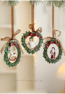 Three retro resin Christmas ornaments including rocking horse and angel on warm background