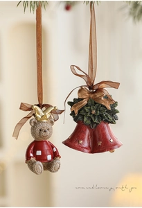 Detailed view of vintage teddy bear ornament and red Christmas bells with festive ribbons