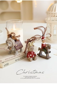 Three-piece set of resin Christmas ornaments featuring puppy, bear, and elf with bows