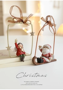 Detail of vintage Christmas resin ornaments featuring Santa and angel with festive ribbons