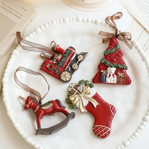 Set of 4 vintage resin Christmas ornaments featuring train, tree, horse, and stocking
