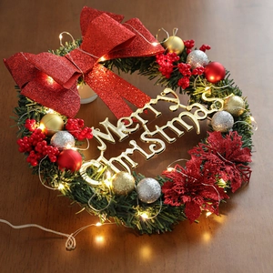 Couronne de Noël 30cm avec LED, nœuds rouges, baies et signe Joyeux Noël doré