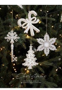 Close-up of elegant white and gold Christmas ornaments with warm LED lighting detail