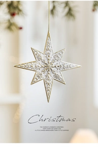 Detail of white and gold star ornament with baroque patterns and golden string