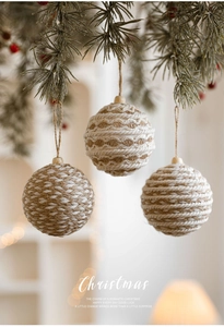 Close-up of 8cm woven jute and cotton Christmas ball ornaments with natural wood beads