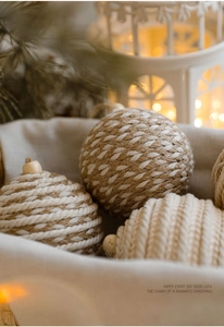 Detail of handwoven Christmas ball ornament with natural rope texture and wooden bead
