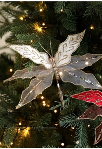 Detail of white mesh butterfly ornament with gold glitter on a Christmas tree