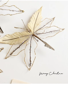 Detailed view of mesh butterfly clip with gold sequins and silver metal alligator clip