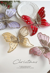 Detail of velvet Christmas butterfly clips with gold glitter and faux diamonds