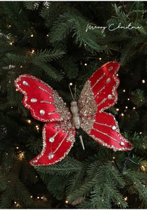 Detail of red velvet butterfly ornament with gold sequins and crystals on a Christmas tree