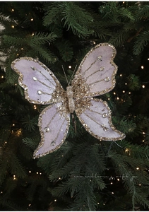 Detail of purple velvet butterfly clip with gold sequins on Christmas tree branch
