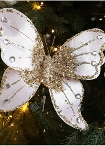 Detail of white fabric Christmas butterfly clip with gold glitter edges and rhinestones
