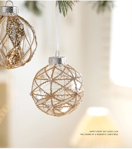 Detail of 8cm clear Christmas ball ornament with gold glitter grid and pearl accents