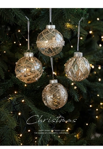 Close-up of 8cm clear Christmas ball ornaments with gold glitter and pearl beads on tree