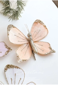 Detail of pink Christmas butterfly clip with gold glitter, pearls, and metal clamp
