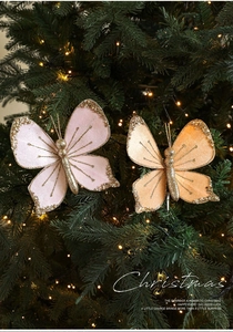 Detailed view of velvet butterfly ornaments with glitter beads on Christmas tree branches