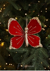 Detailed view of a red velvet Christmas butterfly ornament with gold sequins and beads