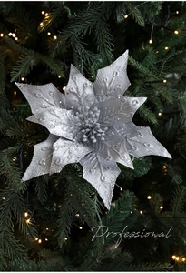 Close-up of artificial silver poinsettia with glitter petals on a Christmas tree