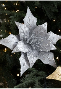 Close-up of 29cm silver sequined Christmas poinsettia flower on a decorated tree
