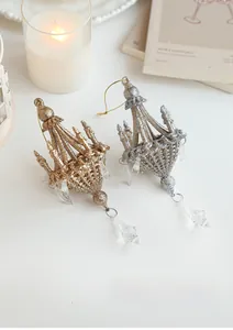 Close-up of elegant gold and silver glitter chandelier ornaments with crystal pendants