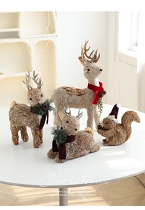 Detailed view of sisal fiber Christmas reindeer and squirrel figures with red festive hats