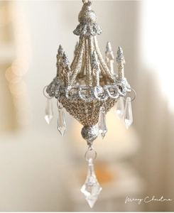 Macro shot of gold and silver glitter chandelier ornament with clear crystal teardrops
