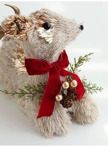 Detail of reindeer decor featuring sisal texture, red velvet bow, and golden berries