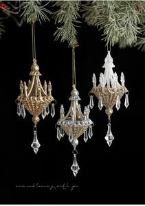 Close-up of glittered chandelier Christmas ornaments with crystal drops on pine branch