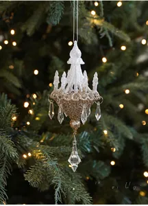 Macro detail of chandelier Christmas ornament with gold glitter and crystal pendants