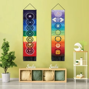 Vertical chakra tapestry set with black tassels shown in a zen living room setting