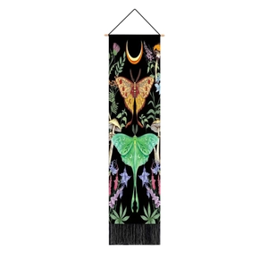 Detail of floral butterfly moon tapestry with vintage wood rod and black fringe tassels