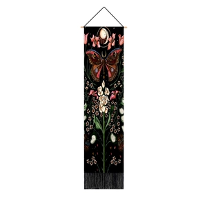 Detail of black butterfly and moon phase tapestry with vintage floral patterns and tassels