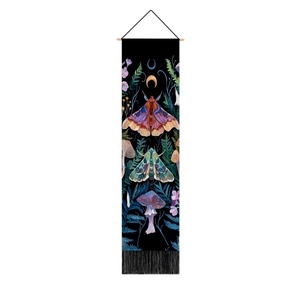 Close-up of vintage forest tapestry featuring moths, mushrooms, and hanging tassels